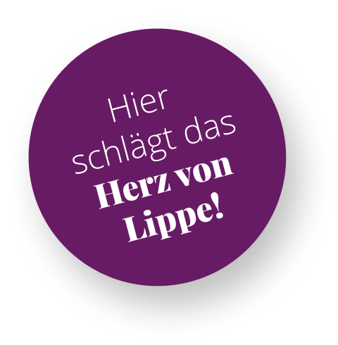 Ein lila Kreis mit weißem Text. Der Text lautet: Hier schlägt das Herz von Lippe!